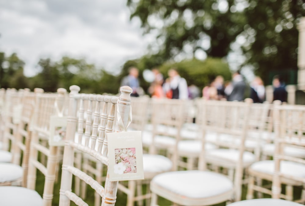 Wedding ceremony chairs arranged on a lawn at Kaʻala Vista with sweeping North Shore mountain views in the background.