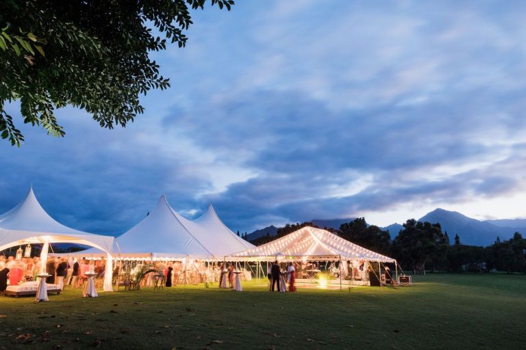 Makai Golf Club wedding ceremony overlooking ocean cliffs with lush fairways and dramatic Kauaʻi coastline views.