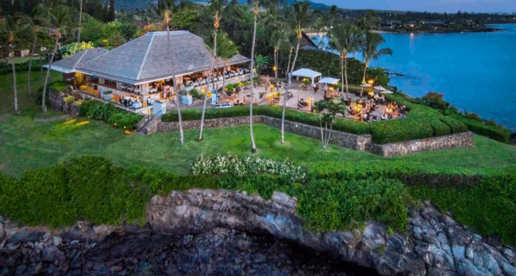 Bird’s-eye view of Merriman’s in Hawaii, highlighting the scenic location with ocean views, tropical landscaping, and the restaurant buildings.