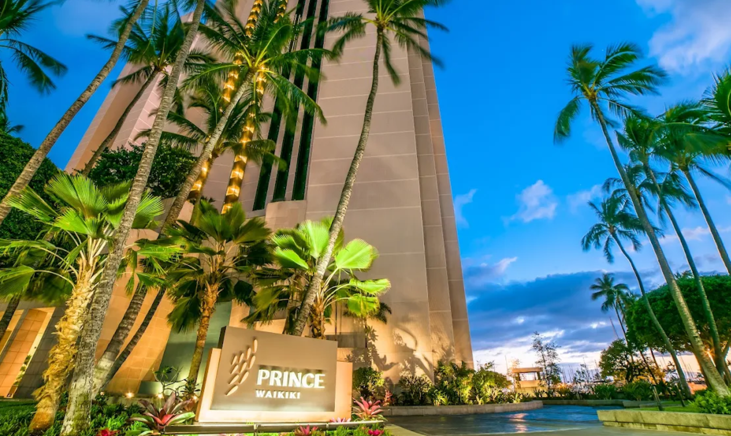 Exterior view of the Prince Waikiki hotel in Honolulu, highlighting its sleek modern design and entrance area.